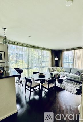 San Diego condo for rent - A dining room with a table set for four and a couch in the background.