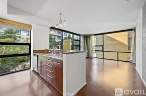 San Diego condo for rent - A modern kitchen with white cabinets and a wooden countertop.