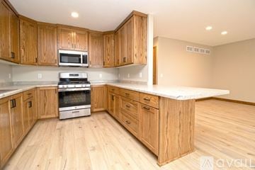 Big Lake apartment for rent - A kitchen with white cabinets and a granite countertop.