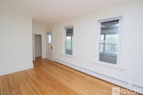 Big Lake apartment for rent - A spacious room with a window and a door on the left side.
