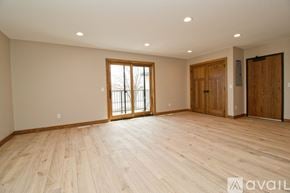 Big Lake apartment for rent - A room with a carpeted floor and a window showing trees outside.