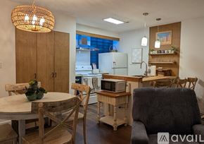 Little River condo for rent - A kitchen with a table and chairs in the foreground and a refrigerator in the background.