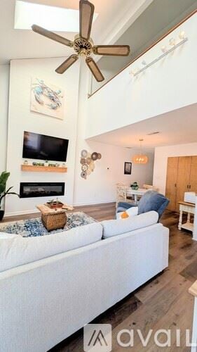 Little River condo for rent - A living room with a white couch and a ceiling fan.