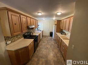 Ithaca house for rent - A kitchen with wooden cabinets and a checkered floor.