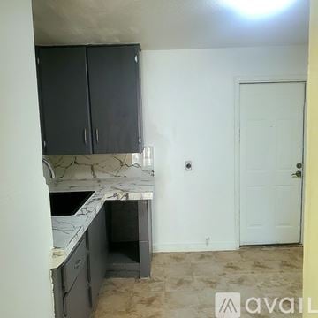 Brownsville house for rent - A kitchen with a counter and cabinets is available for rent.