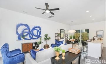 Charlotte house for rent - A living room with a blue chair and a large blue painting on the wall.