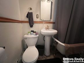 Boston apartment for rent - A bathroom with a toilet, sink, and bathtub.