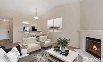 Carlsbad apartment for rent - A living room with a fireplace and a painting on the wall.