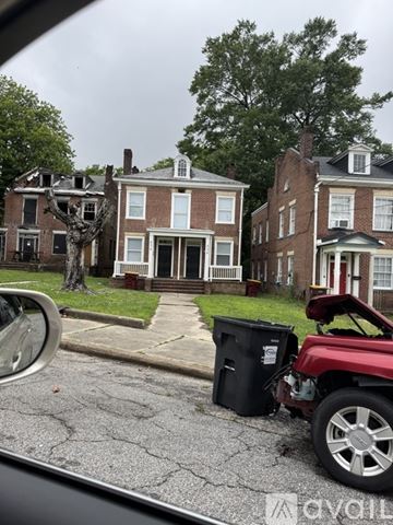 Petersburg apartment for rent - A car is parked on a street with a red vehicle in front of it.