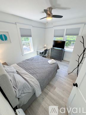 San Diego apartment for rent - A bedroom with a bed, dresser, and ceiling fan.