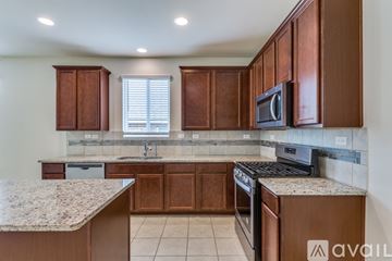 San Antonio house for rent - A kitchen with brown cabinets and a granite countertop.