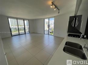 Miami condo for rent - A spacious kitchen with a large island and double sinks.