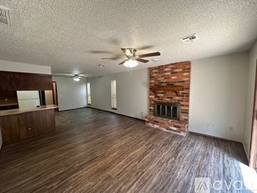 Oklahoma City house for rent - A kitchen with a white fridge and brown cabinets.