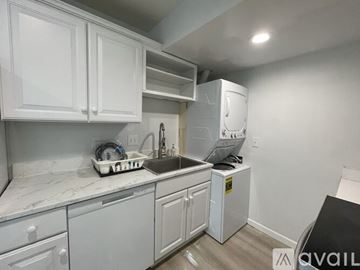 Fairfax apartment for rent - A kitchen with white cabinets and a marble countertop.
