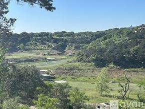 Spicewood house for rent - A rural landscape with trees and a clear sky.