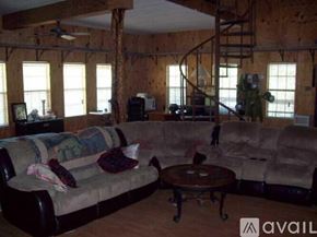 Spicewood house for rent - A living room with a couch, a coffee table, and a TV.