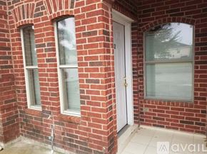 Pharr apartment for rent - A red brick house with a white door and windows.