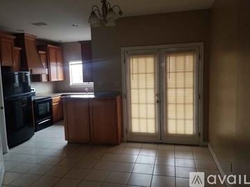 Pharr apartment for rent - A kitchen with wooden cabinets and black appliances is available for rent.