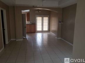 Pharr apartment for rent - A spacious room with tile flooring and a window letting in natural light.