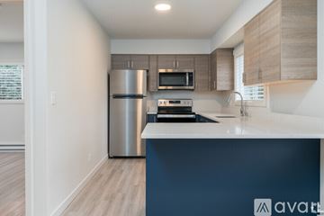 Coeur D'alene apartment for rent - A kitchen with a stainless steel refrigerator and a white countertop.