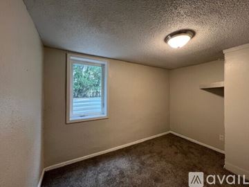 Rapid City apartment for rent - A kitchen with wooden cabinets and a white stove top oven.