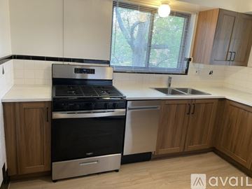 Cincinnati apartment for rent - A kitchen with wooden cabinets and a white refrigerator.