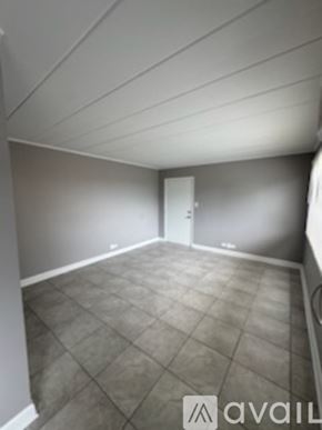 Schiller Park apartment for rent - A room with a tile floor and a door in the background.