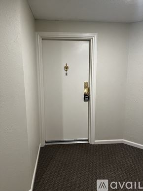 Frederick condo for rent - A room with a carpeted floor and a sliding glass door leading to a deck.