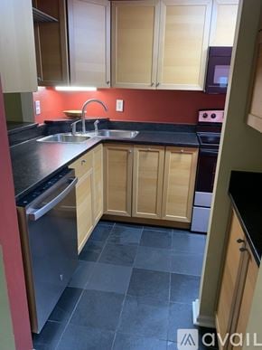 Frederick condo for rent - A bathroom with a sink, toilet and mirror.