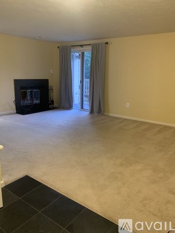Frederick condo for rent - A kitchen with wooden cabinets and black countertops.