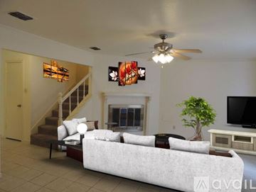 Houston house for rent - A living room with a white couch and a ceiling fan.