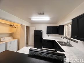 Houston house for rent - A room with a door, a window with bars, and a mirror on the wall.