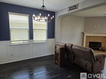 Liberty Hill house for rent - A living room with a brown couch and a fireplace.