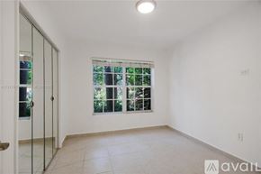 Key Biscayne house for rent - A room with a sliding glass door leading to a balcony.