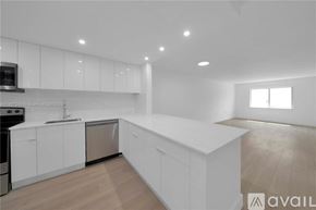 Key Biscayne apartment for rent - A modern kitchen with white cabinets and a wooden floor.
