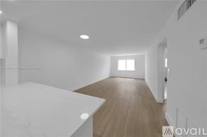 Key Biscayne apartment for rent - A spacious room with wooden flooring and white walls.