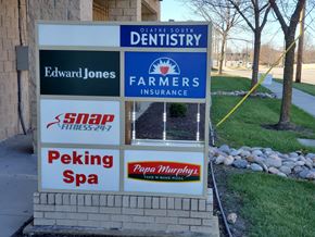 Olathe apartment for rent - A sign for Edward Jones is on a signpost with other businesses.