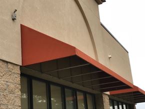 Olathe apartment for rent - A building with a red awning over a window.