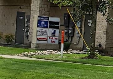 Olathe apartment for rent - A sign in front of a building advertises a dentist and a spa.