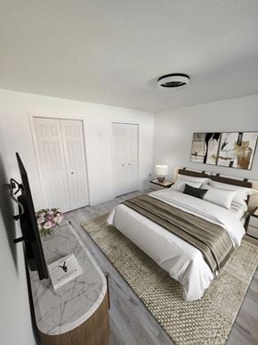 Acton apartment for rent - A bedroom with a large bed and a television on a stand.