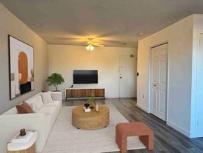 Acton apartment for rent - A living room with a white couch, a wooden coffee table, and a flat screen TV.