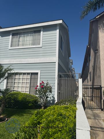 Hawthorne apartment for rent - A blue house with a white fence and a gate.