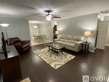 Lexington apartment for rent - A living room with a brown leather chair and a white couch.