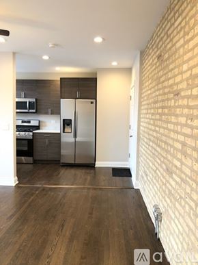 Chicago apartment for rent - A kitchen with a refrigerator, microwave, and oven.