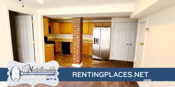 Augusta apartment for rent - A kitchen with wooden cabinets and a brick chimney.