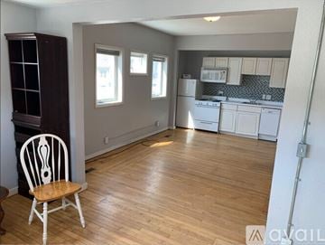 Mankato apartment for rent - A kitchen with a wooden floor and white walls.