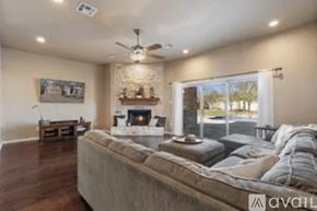Austin house for rent - A bedroom with a large bed and a fireplace.