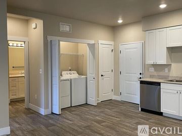 Missoula apartment for rent - A kitchen with white cabinets and a wooden floor.