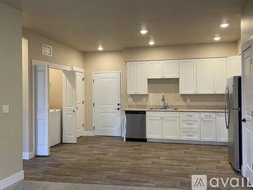 Missoula apartment for rent - A kitchen with white cabinets and a refrigerator.