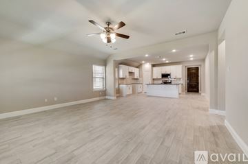 Forney house for rent - A spacious living room with a ceiling fan and lighting fixtures.